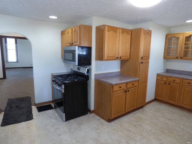 kitchen with stainless steel appliances and a textured ceiling