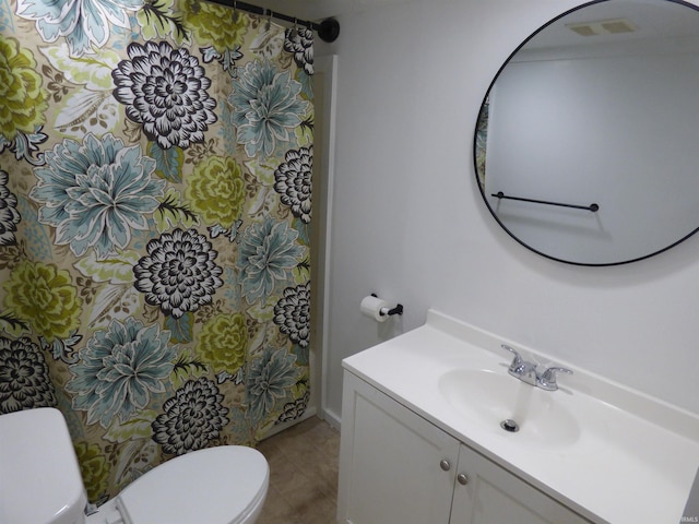 bathroom with vanity, tile patterned floors, and toilet