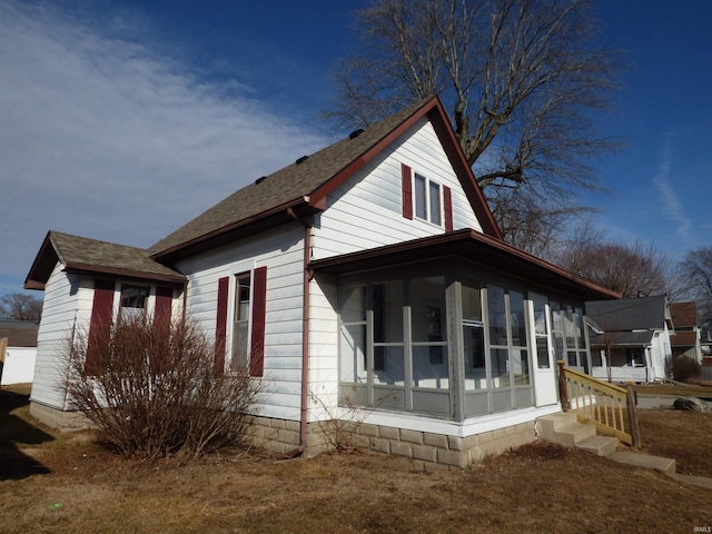 view of side of property featuring a sunroom