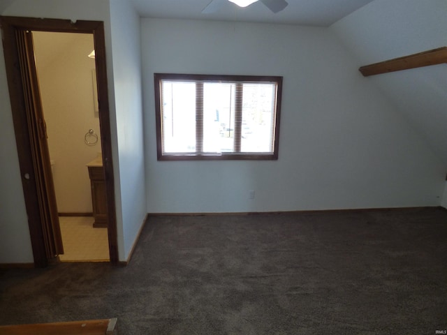 bonus room featuring dark colored carpet, lofted ceiling, and ceiling fan