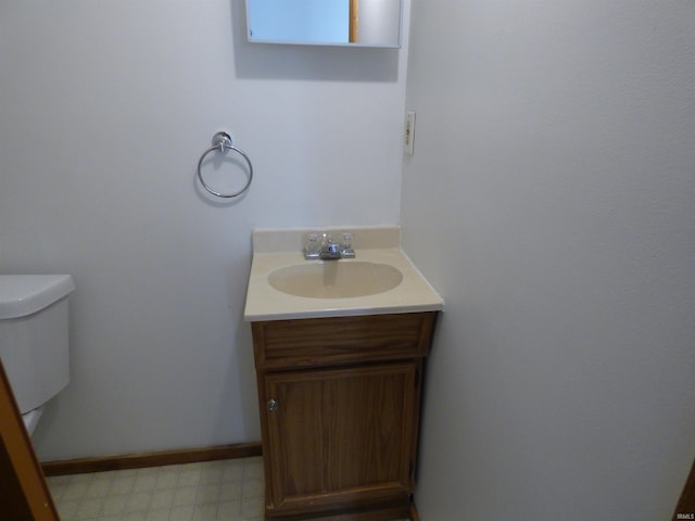 bathroom featuring vanity and toilet