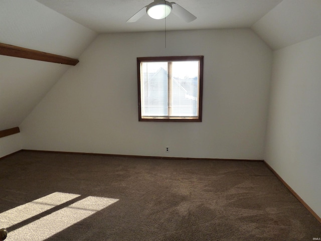 additional living space featuring vaulted ceiling, ceiling fan, and dark carpet