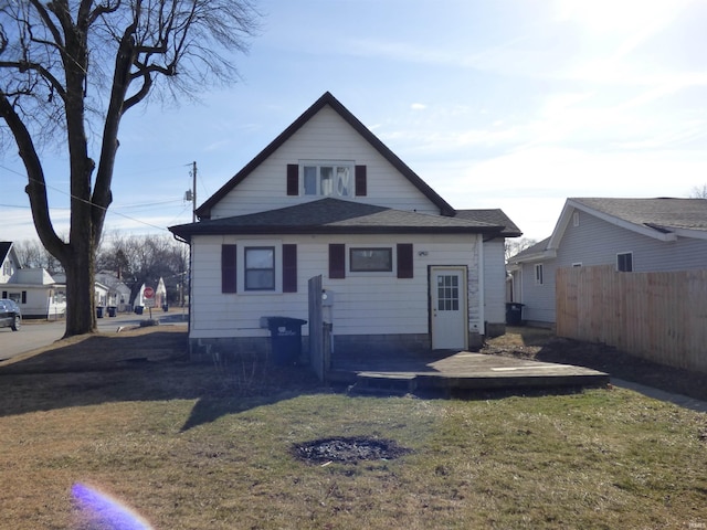 rear view of property with a yard