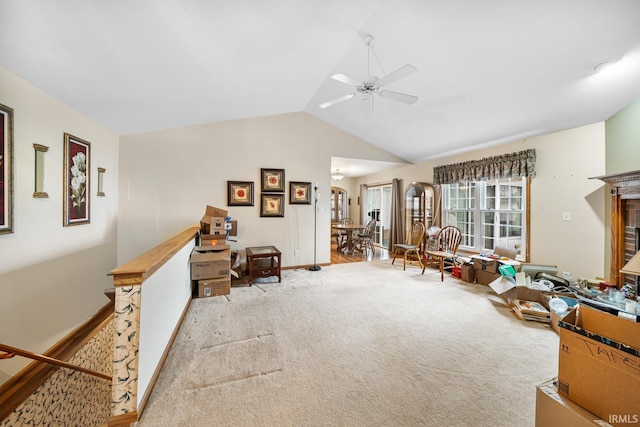 interior space featuring vaulted ceiling, light colored carpet, and ceiling fan