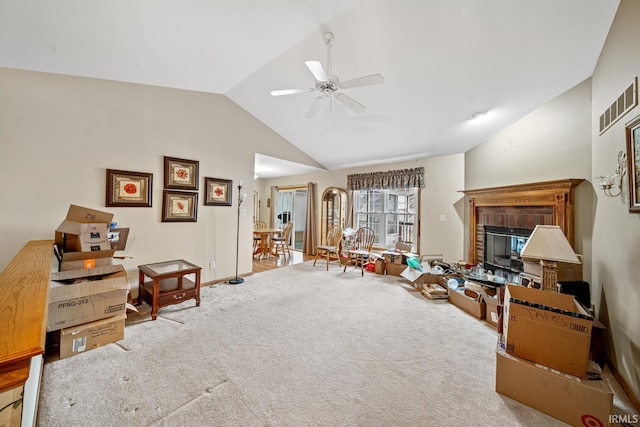 living room with vaulted ceiling, carpet flooring, and ceiling fan