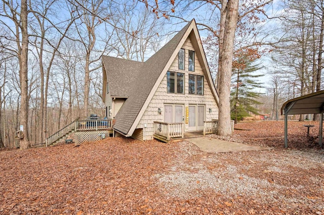 view of front facade with a wooden deck and a carport