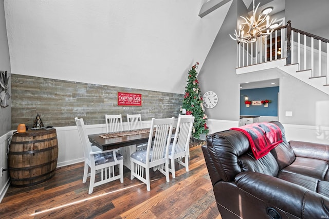 dining space with an inviting chandelier, dark hardwood / wood-style flooring, and lofted ceiling