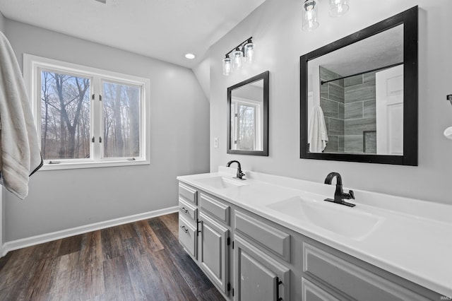 bathroom featuring vanity, hardwood / wood-style floors, and walk in shower