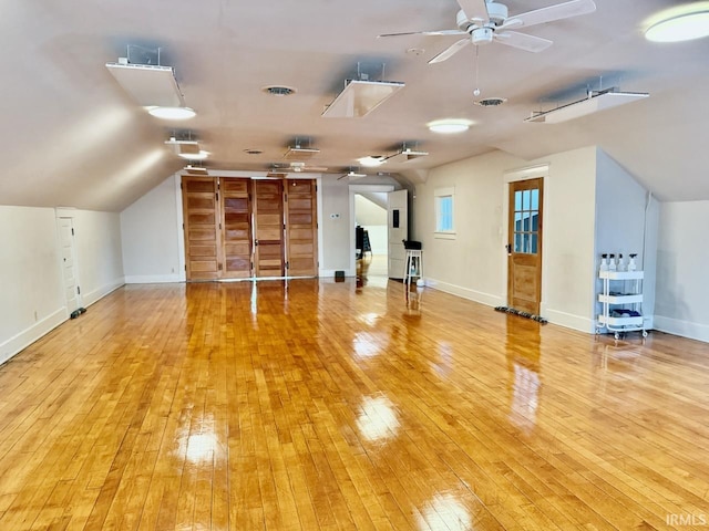 interior space with ceiling fan, vaulted ceiling, and light hardwood / wood-style flooring