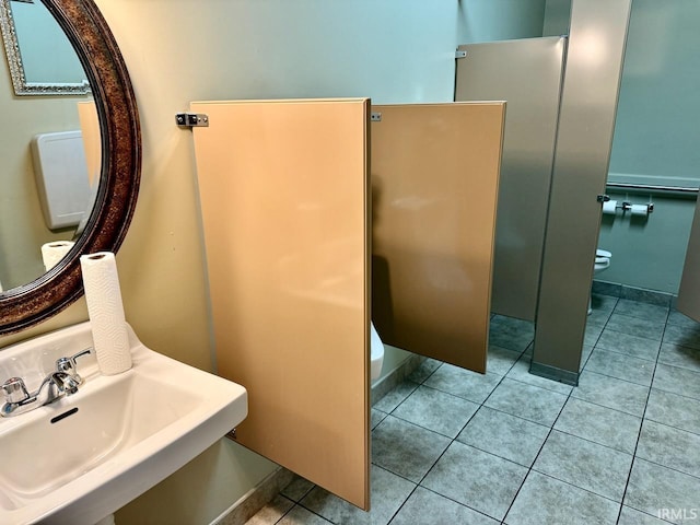 bathroom featuring sink, tile patterned floors, and toilet