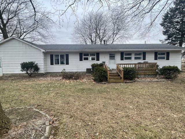 single story home with a wooden deck, a front lawn, and cooling unit