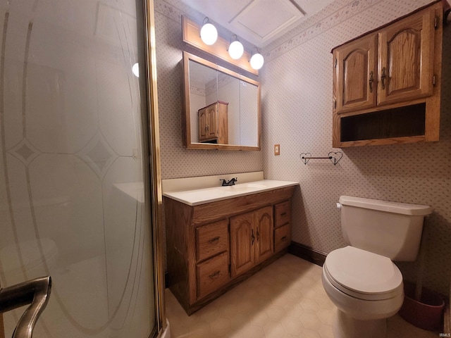 bathroom with a shower with door, vanity, and toilet