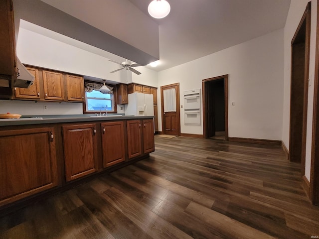 kitchen featuring dark hardwood / wood-style floors, ceiling fan, sink, and white appliances