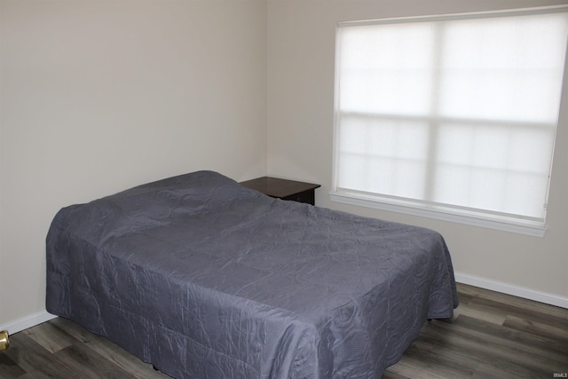 bedroom featuring dark hardwood / wood-style flooring