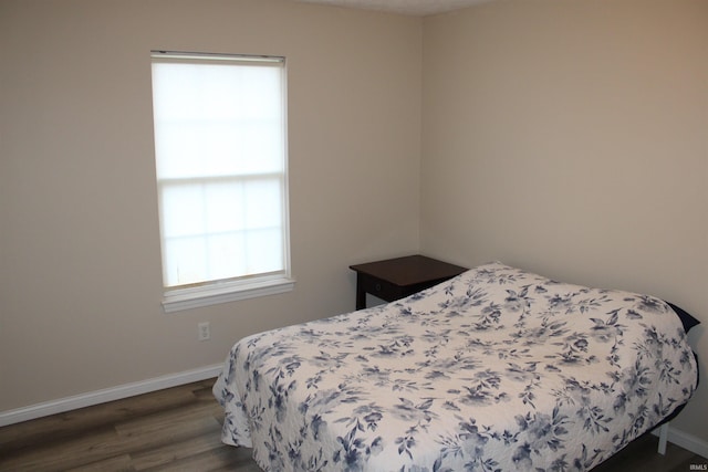 bedroom featuring dark wood-type flooring