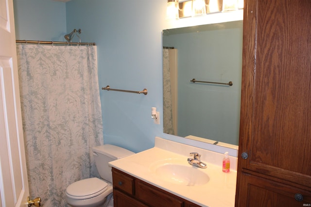 bathroom with vanity, toilet, and a shower with shower curtain