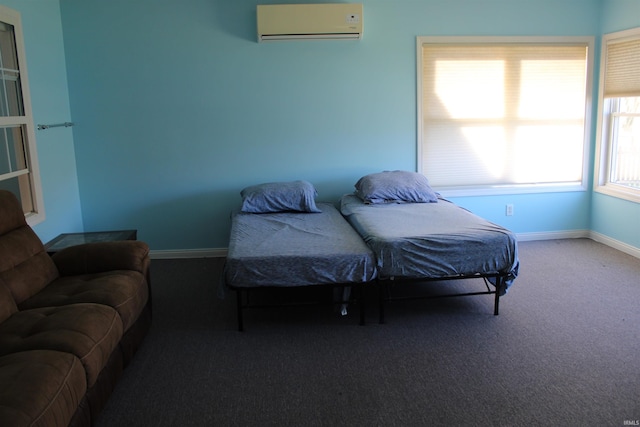 bedroom with carpet floors and a wall unit AC