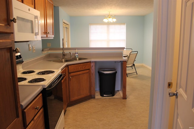 kitchen featuring decorative light fixtures, sink, a chandelier, electric range, and a textured ceiling