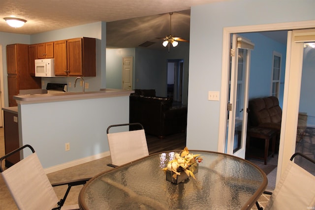 dining room featuring sink, a textured ceiling, and ceiling fan