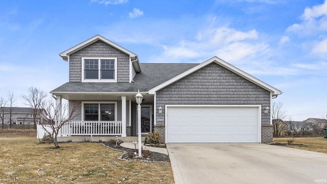 view of front of home with a porch, a garage, and a front lawn