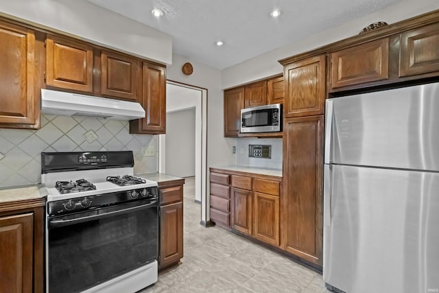 kitchen featuring stainless steel appliances and backsplash