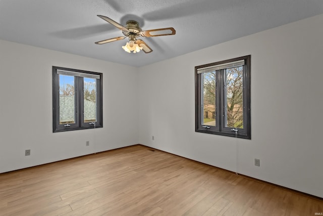 spare room featuring ceiling fan, a textured ceiling, and light hardwood / wood-style floors