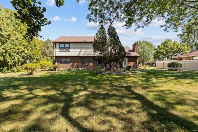 rear view of house with a yard