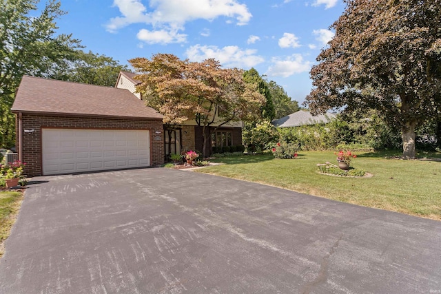 view of front of property with a garage and a front yard