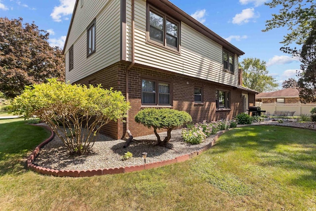 view of home's exterior with a lawn