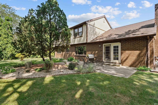 back of property featuring a yard and a patio area