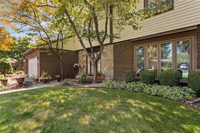 view of front of property with a garage and a front yard