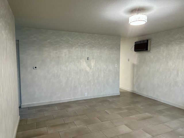 unfurnished room featuring a wall unit AC