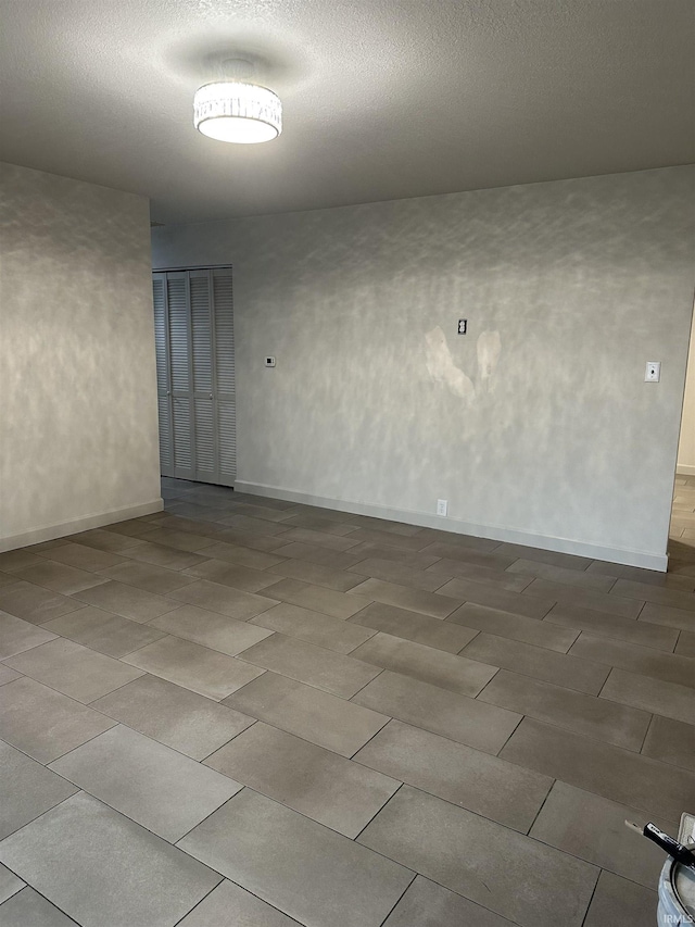 spare room with a textured ceiling