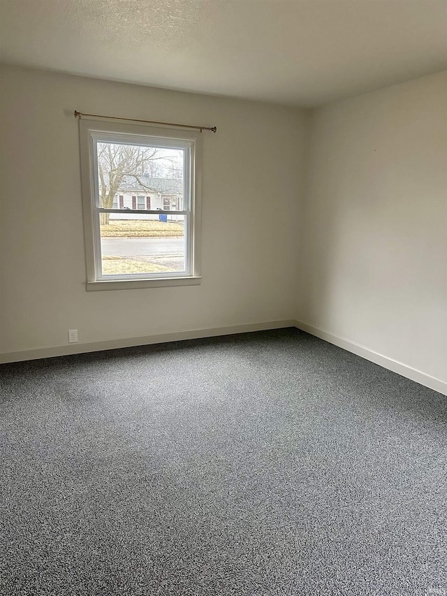 unfurnished room with a textured ceiling