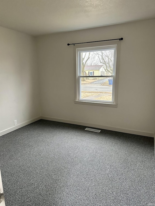 unfurnished room featuring a textured ceiling