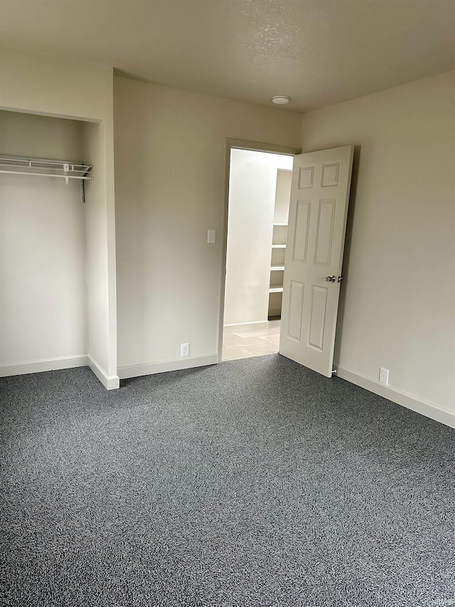 unfurnished bedroom featuring a closet and a textured ceiling