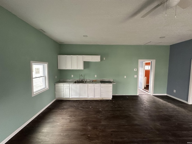 kitchen featuring dark wood-type flooring, sink, white cabinetry, a textured ceiling, and ceiling fan