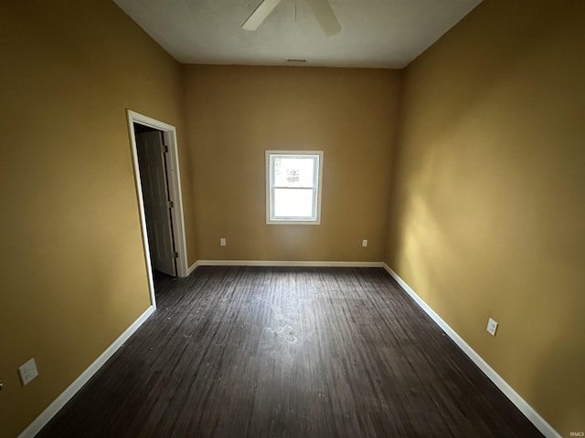 empty room with ceiling fan and dark hardwood / wood-style flooring