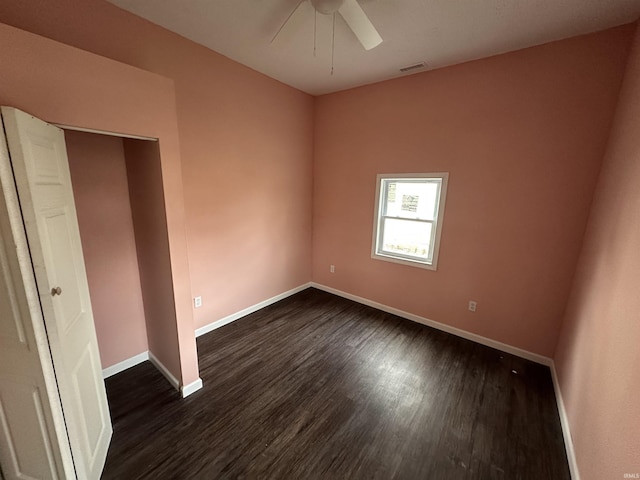 unfurnished bedroom with dark wood-type flooring and ceiling fan