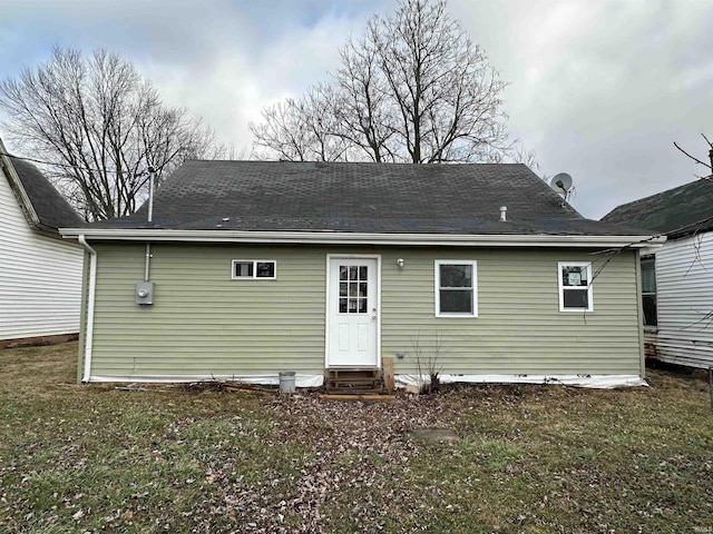 rear view of property featuring a yard