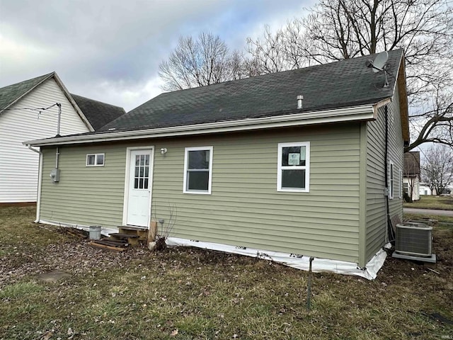 back of house with central air condition unit