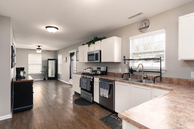 kitchen with white cabinetry, appliances with stainless steel finishes, sink, and a wealth of natural light