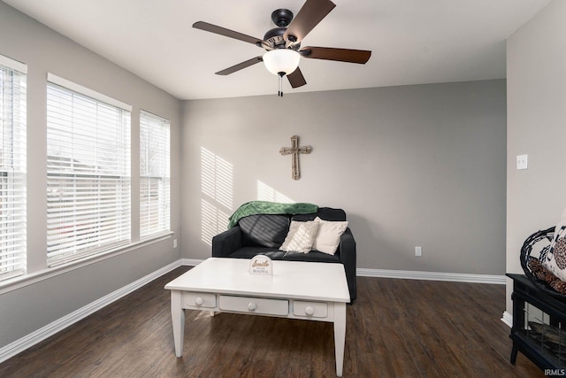 living area featuring ceiling fan and dark hardwood / wood-style flooring