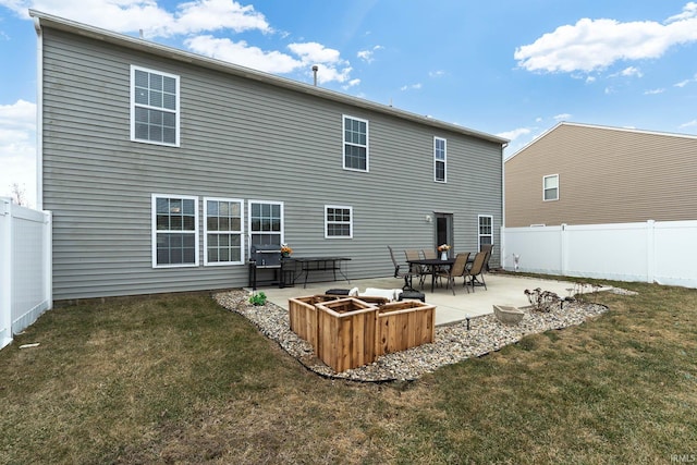 back of house with a lawn and a patio