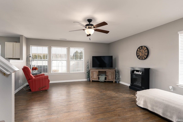 living room with dark hardwood / wood-style flooring and ceiling fan