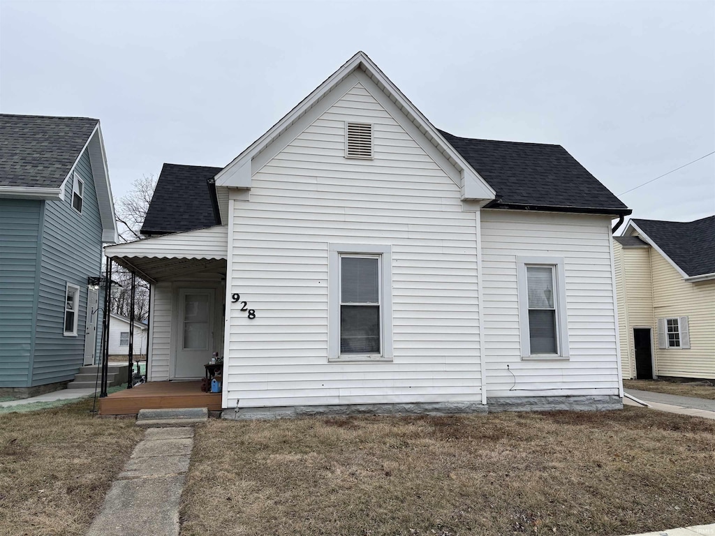 back of house with a lawn