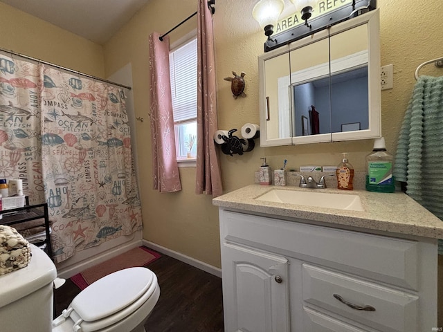 full bathroom with hardwood / wood-style flooring, vanity, shower / bath combo, and toilet