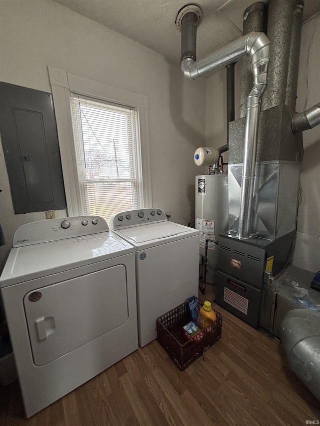 laundry area featuring dark hardwood / wood-style floors, gas water heater, electric panel, and independent washer and dryer