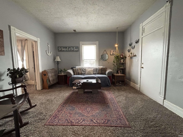 carpeted living room featuring a textured ceiling