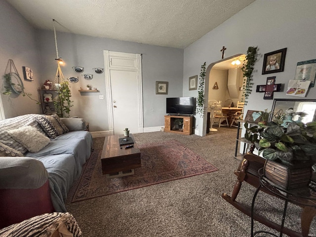 living room featuring carpet flooring, vaulted ceiling, and a textured ceiling